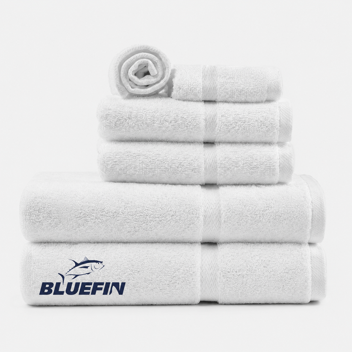 Stack of white towels with Bluefin logo on a white background