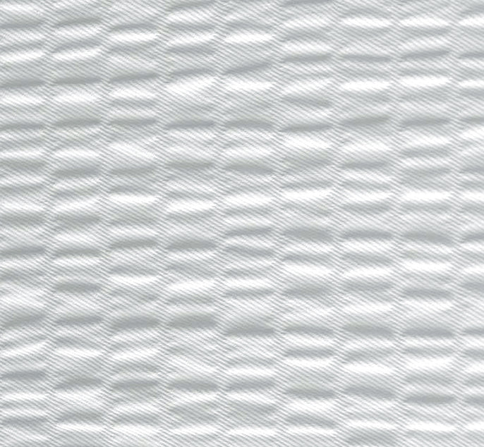 A close-up of a white textured material with a repeating wavy, ribbed pattern.