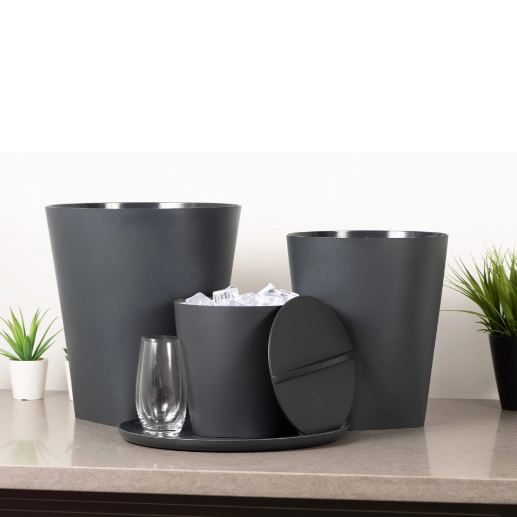 Set of black ice buckets with a small table and glass on a light surface.