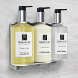 Three Terra Pure Green Tea products on a wall-mounted holder against a tiled wall.