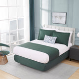 Modern bedroom with a green and white bed, side table, and chair.