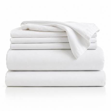 Folded stack of white bed sheets