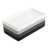 Three-layered tray with white, gray, and black sections on a white background