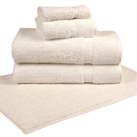 Pictured: Neatly folded stack of white towels on top of a white bath mat against a white background.