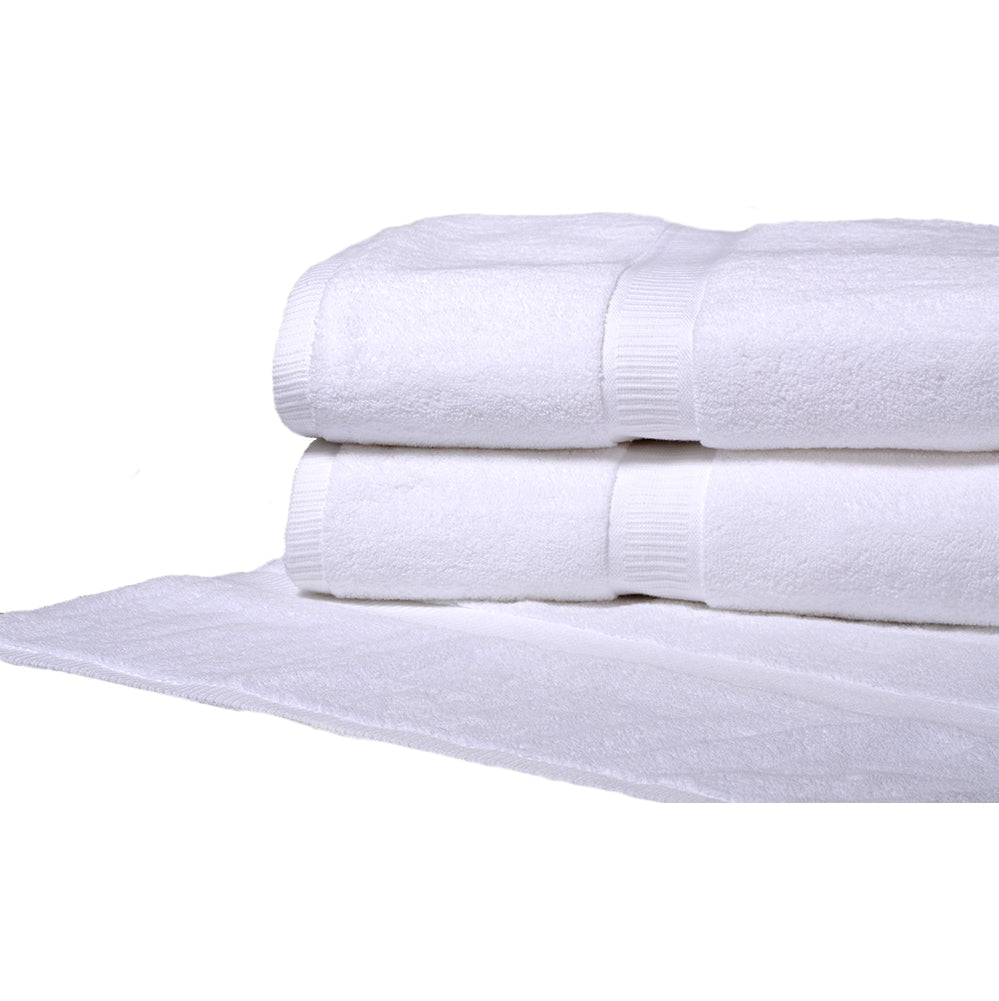 Pictured: Half shot of two white towels neatly folded and stacked on top of a white bath mat against a white background