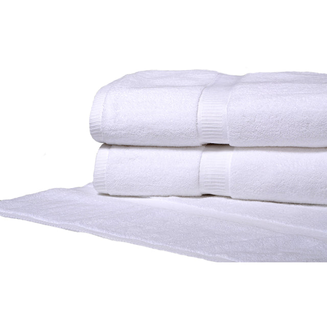 Pictured: Half shot of two white towels neatly folded and stacked on top of a white bath mat against a white background