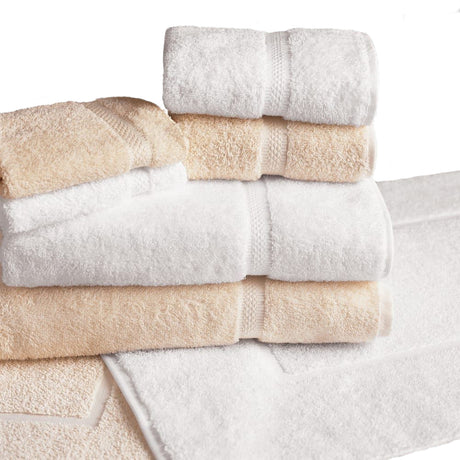 Pictured: White and beige towels neatly folded and stacked on top of one white and one beige bath mat against a white background.