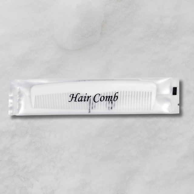 White comb packet labeled 'Hair Comb' on a gray background