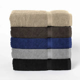 Stack of folded towels in beige, brown, blue, gray, and black on a white background