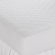 Pictured: A white, fitted Martex Ultra Touch Mattress Pad on a bed, showcasing its quilted design and fitted skirt.