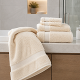 Beige towels on a bathroom counter with a neutral background