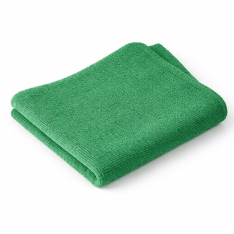 Folded green towel on a white background