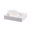 White soap dish with a bar of soap inside on a white background