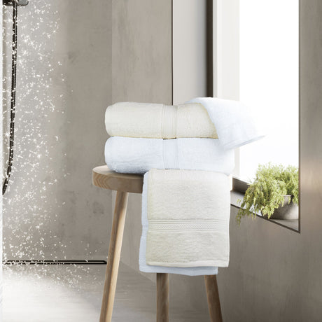White and Ivory towels on a wooden stool by a rainfall shower