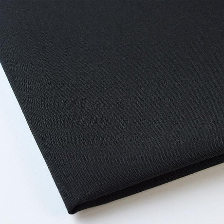 Pictured: Close up of the Premier Napkin neatly folded in the shade Black against a white background.