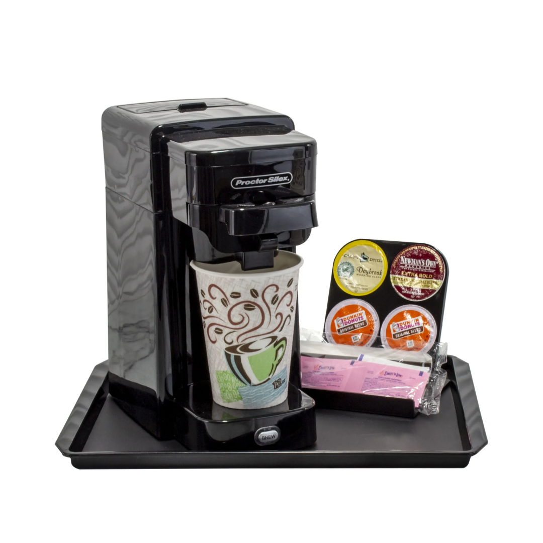 Coffee maker with a coffee cup and packets on a tray