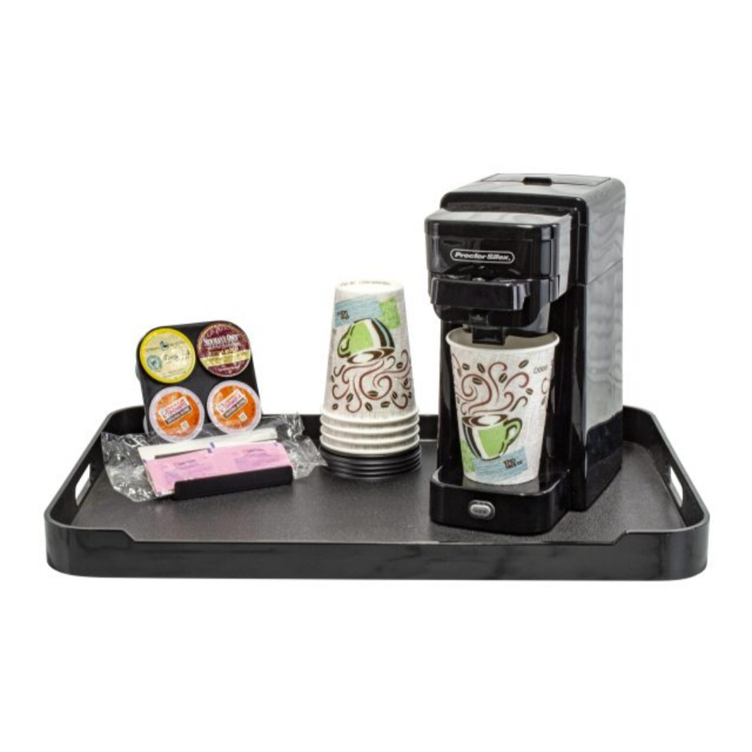 Coffee maker with cups and packaging on a black tray against a white background