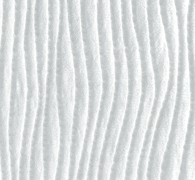 A close-up of a white textured fabric with vertical wavy stitched ridges.