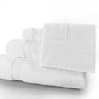 Stack of white towels on a light gray background
