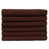 Pictured: Neatly folded stack of 6 warm brown towels against a white background. These towels are in the shade Chocolate.