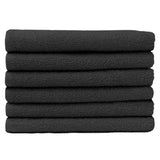 Pictured: Neatly folded stack of 6 deep grey towels against a white background. These towels are in the shade Charcoal.