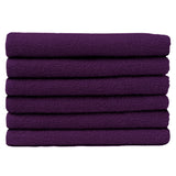 Pictured: Neatly folded stack of 6 purple towels against a white background. These towels are in the shade Eggplant.