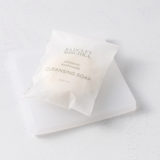 Bar of soap with a clear wrapper on a white background
