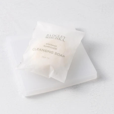 Bar of soap with a clear wrapper on a white background