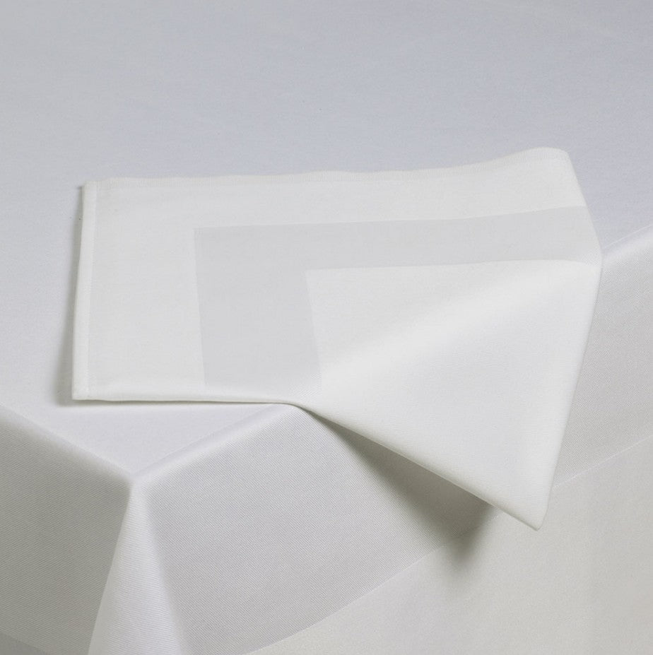 White fabric with geometric folds on a light gray background