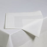 White fabric with geometric folds on a light gray background