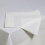White fabric with geometric folds on a light gray background
