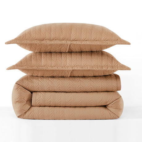 Stack of beige quilted bedding on a white background