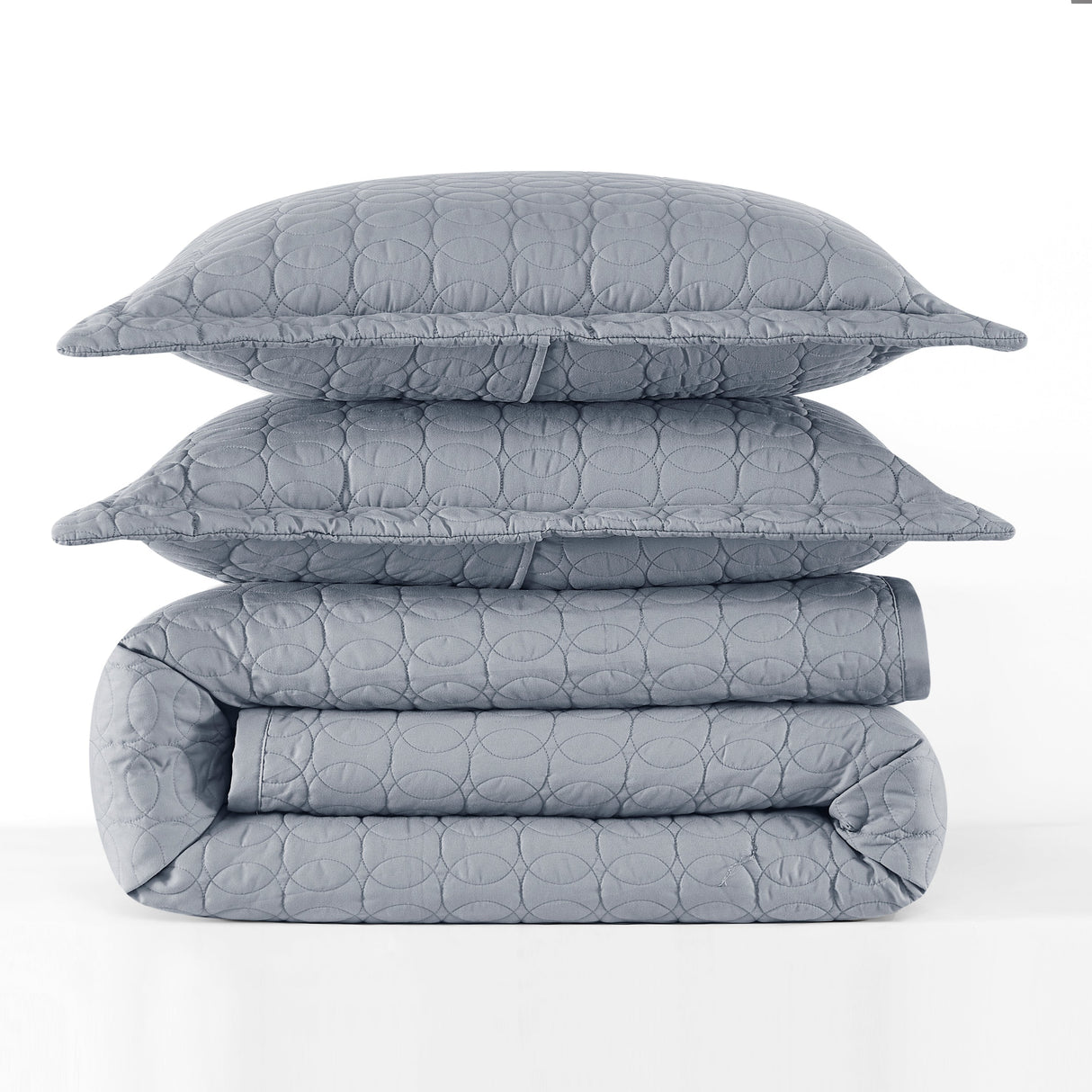 Gray quilt, folded blanket, and pillow on a white background