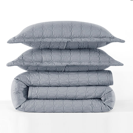 Gray quilt, folded blanket, and pillow on a white background