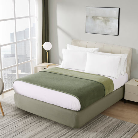 Modern bedroom with a bed, chair, and decor elements.
