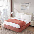 Modern bedroom with a bed, chair, and decor elements.