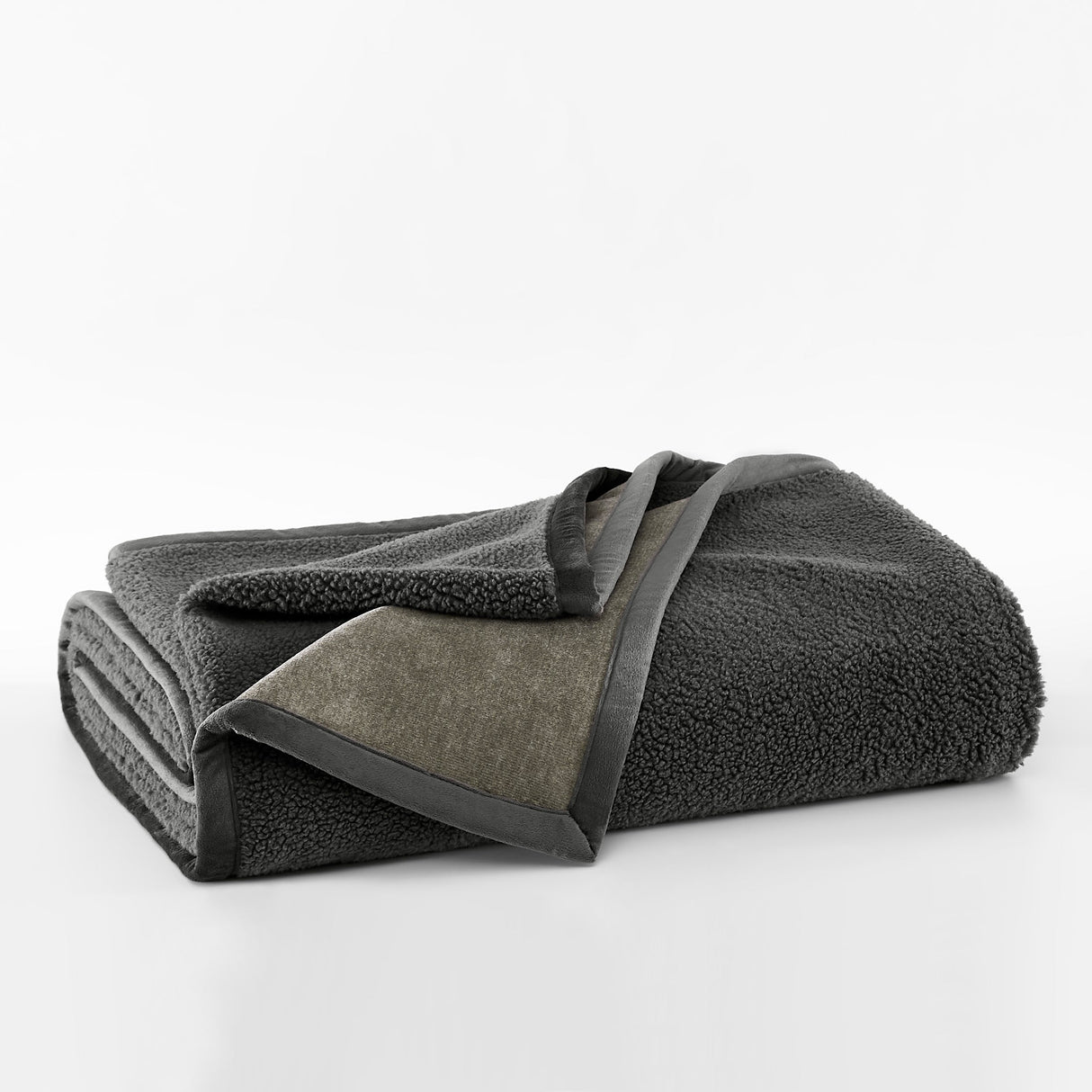 Folded dark gray towel on a white background