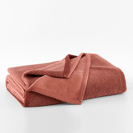 Folded brown towel on a white background