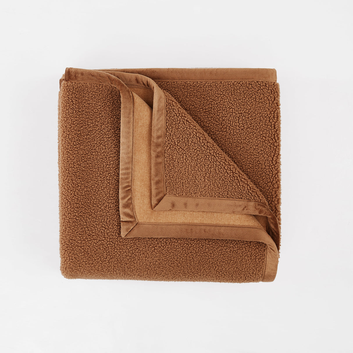 Folded brown blanket on a white background