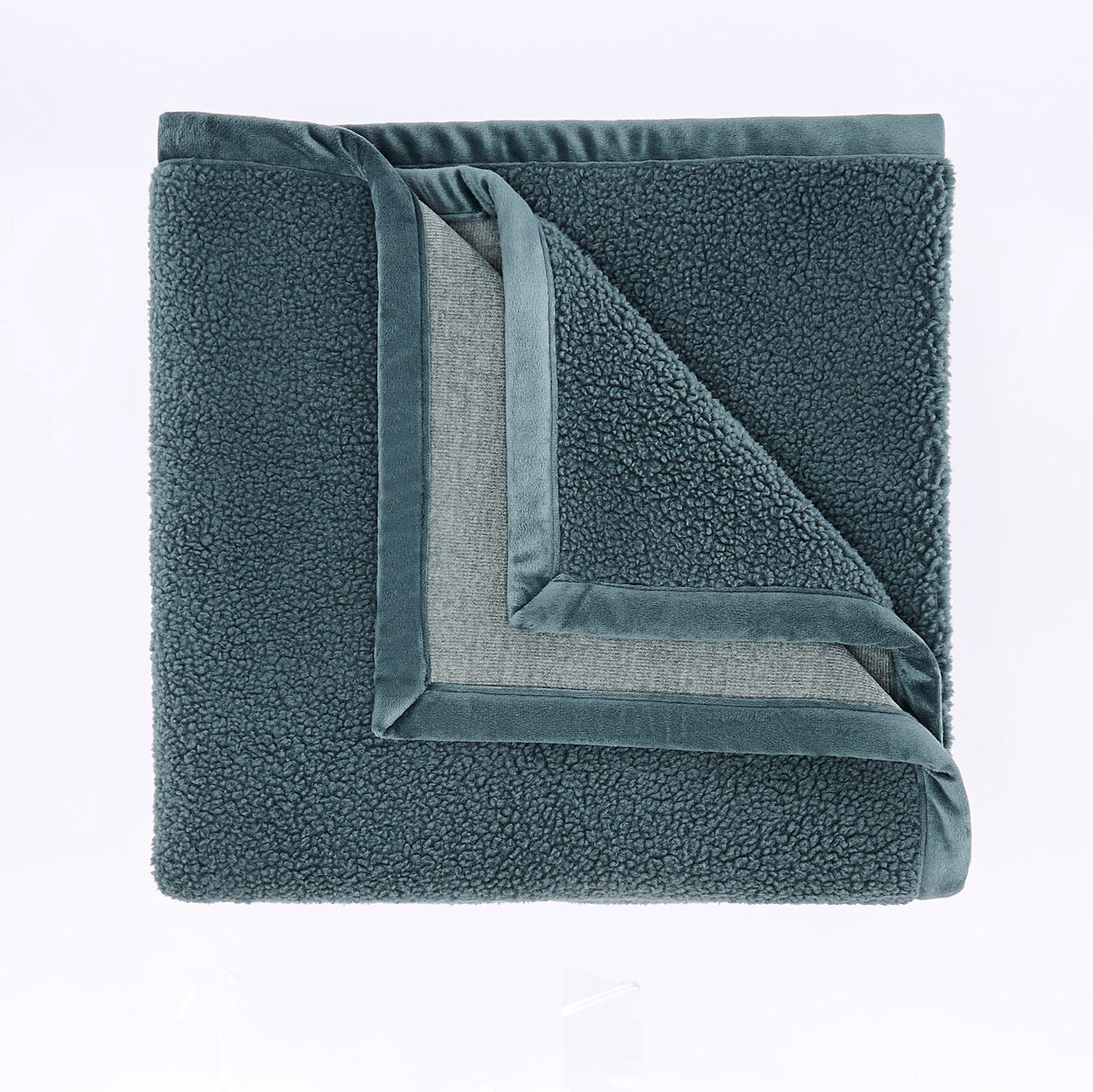 Folded gray fleece blanket on a light purple background