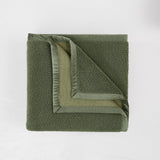 Green textured blanket on a white background