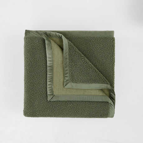 Green textured blanket on a white background