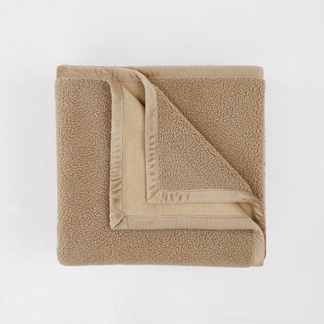Folded beige towel on a white background