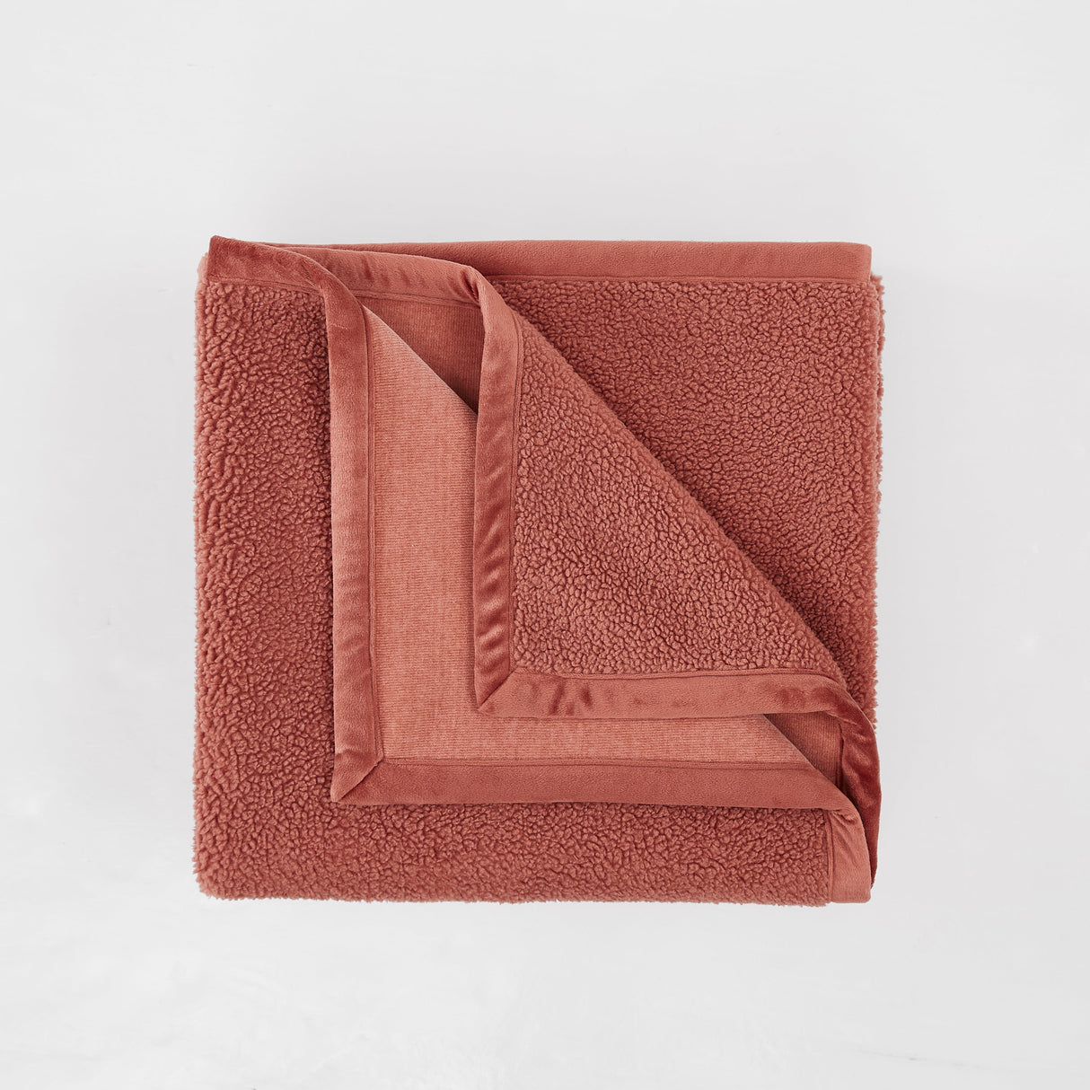 Folded brown towel on a light gray background