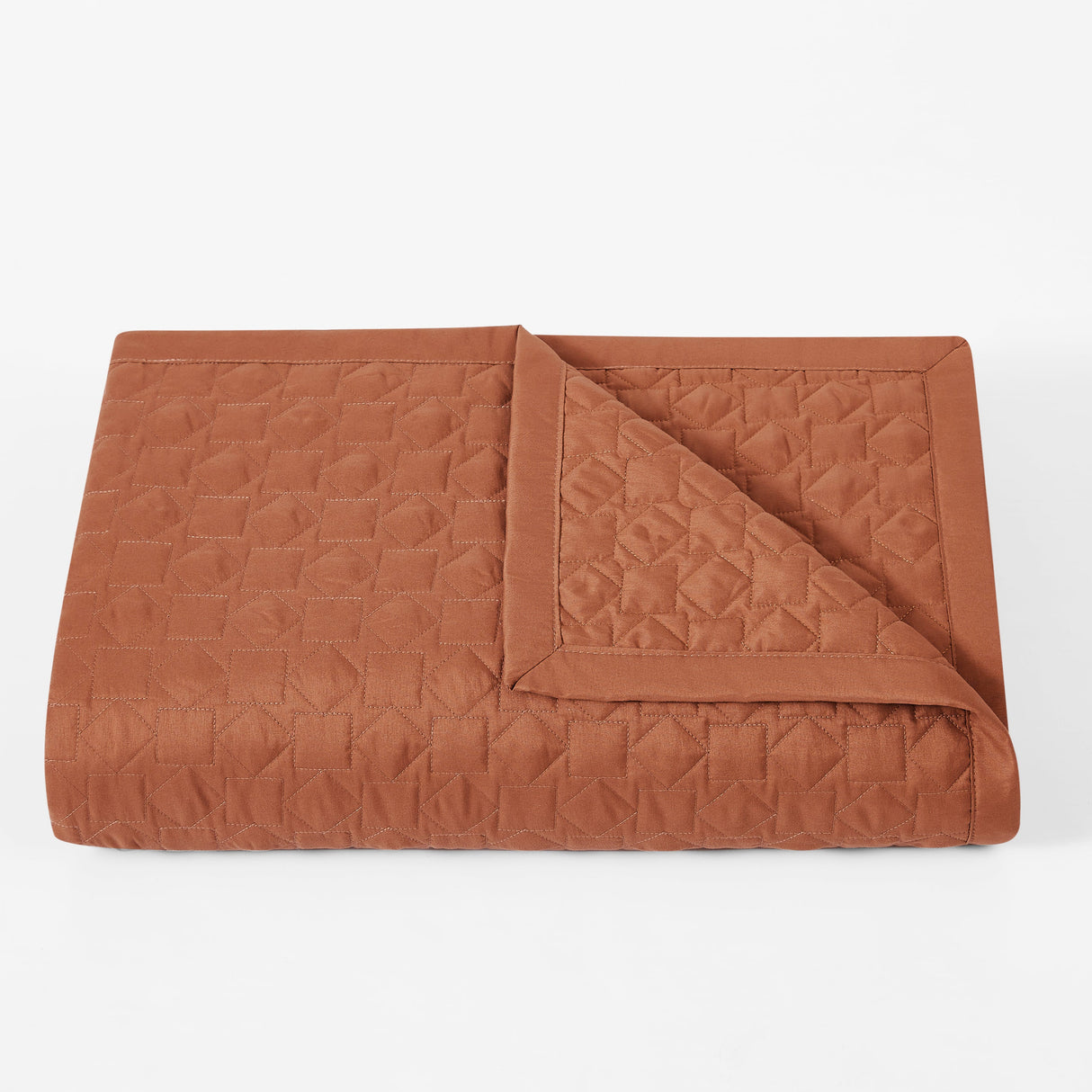 Brown quilted blanket on a white background