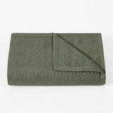 Green textured blanket on a white background