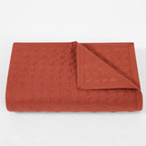 Quilted brown blanket on a white background
