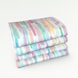Stack of colorful striped fabric on a white background