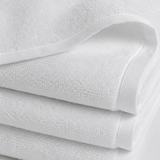 Stack of white towels with a textured surface