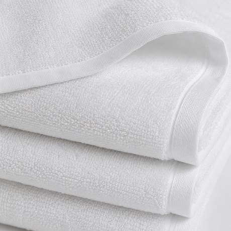 Stack of white towels with a textured surface